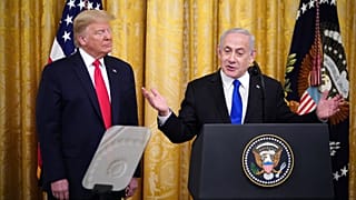Israeli Prime Minister Benjamin Netanyahu, with US President Donald Trump, speaks during an announcement of Trump's Middle East peace plan in White House on January 28, 2020