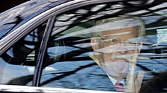 Former National security adviser John Bolton waves as he leaves his home in Bethesda, Md. Tuesday, Jan. 28, 2020