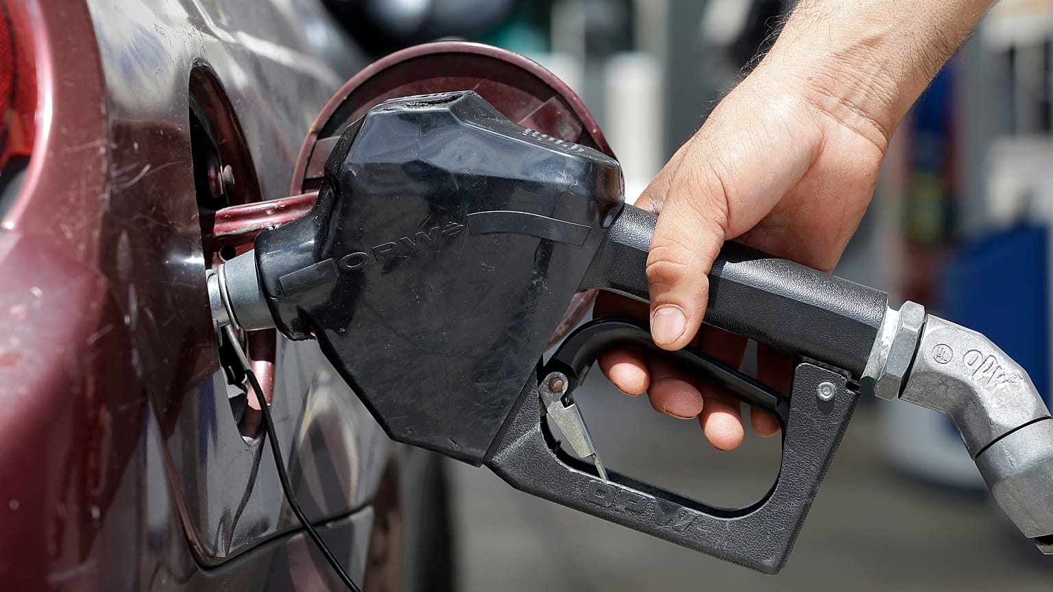 **ATTENTION SHAUN HILL** In this photo taken Tuesday, June 28, 2016, a customer fills his tank, in Miami. (AP Photo/Alan Diaz)