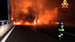 In this photo released by the Italian Firefighters, firemen try to extinguish a dozen vehicles on fire on a highway near Milan, Italy, in the early hours on Jan. 29.