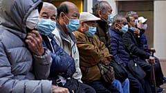 Elderly men sit at a park in Hong Kong, Thursday, Jan. 30, 2020. 