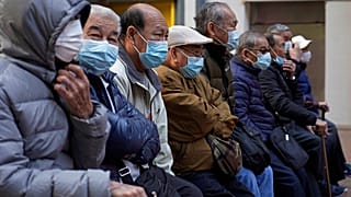 Elderly men sit at a park in Hong Kong, Thursday, Jan. 30, 2020.