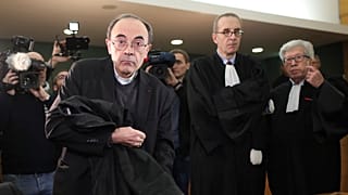 Cardinal Philippe Barbarin takes his seat as he arrives at the Lyon courthouse with his lawyers to attend his trial, in Lyon, Monday Jan. 7, 2019