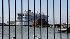 The Costa Smeralda cruise ship is seen behind a fence at it is docked in the Civitavecchia port on January 30, 2020