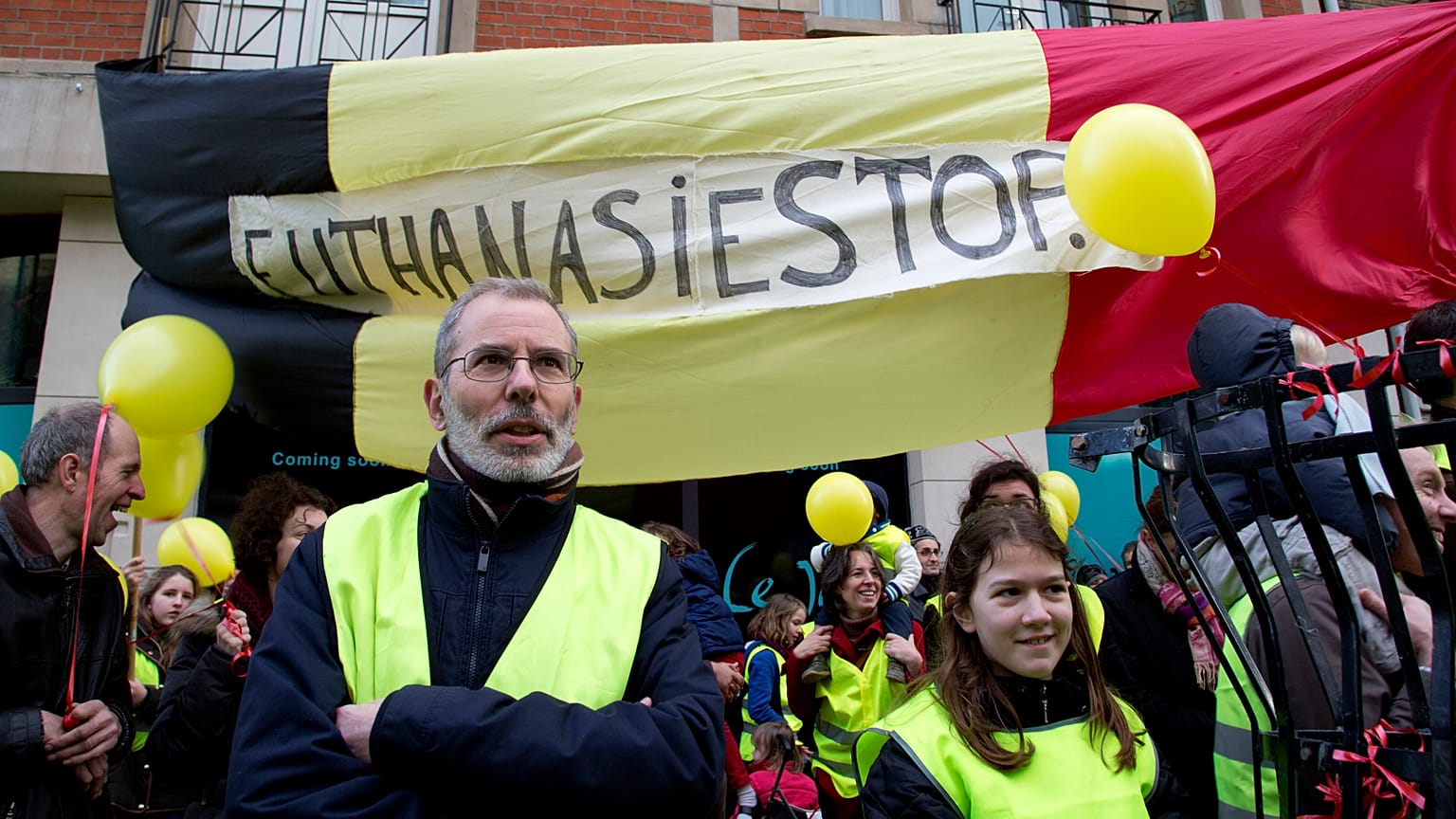 protestors stand in front of a banner which reads "Euthanasia Stop", during an anti-euthanasia demonstration in Brussels in February 2014.