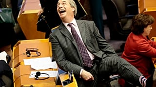 Brexit Party leader Nigel Farage, shows off his Union flag socks ahead of a vote on the UK’s withdrawal from the EU at the European Parliament in Brussels.