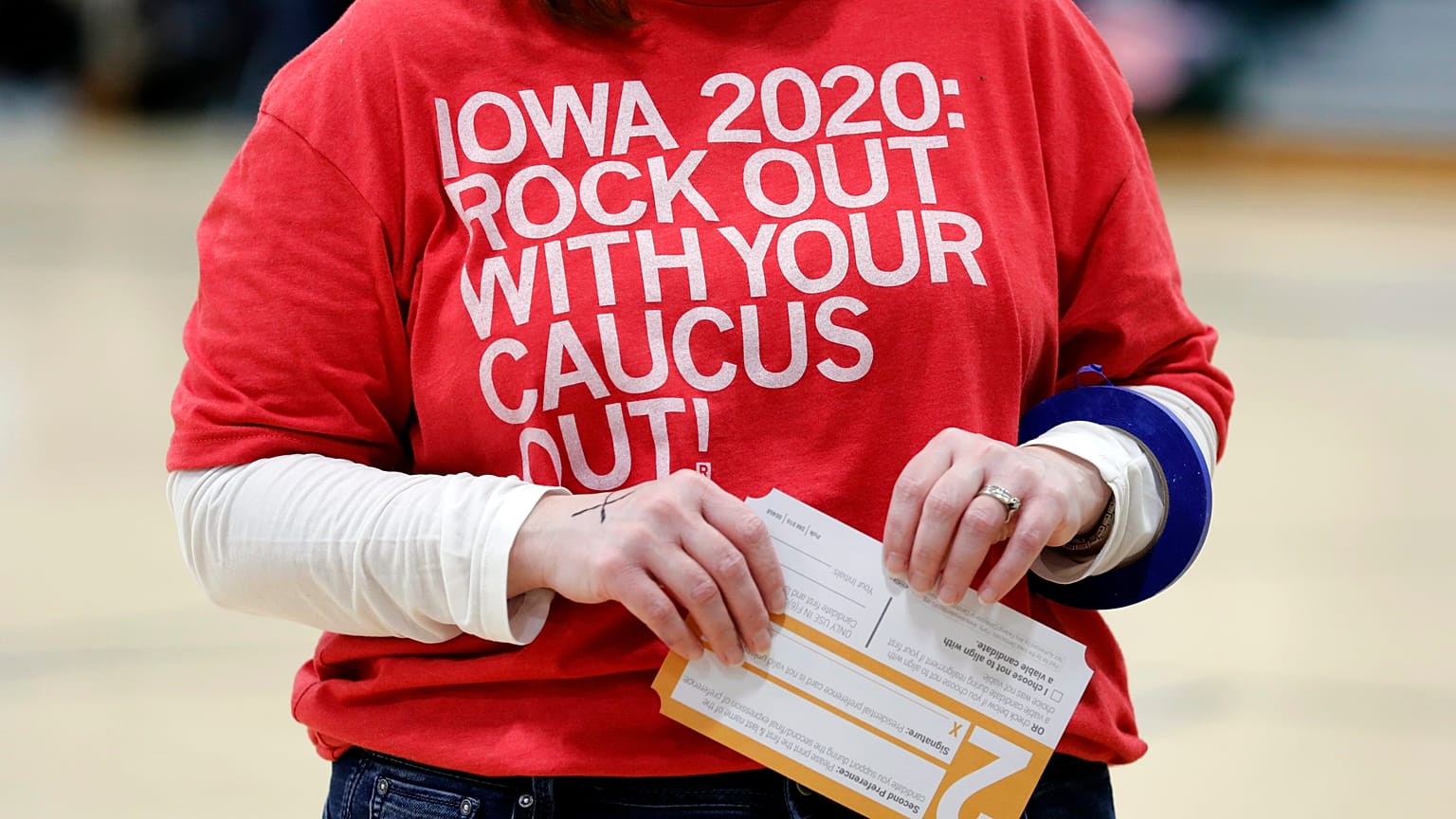 A local resident holds a Presidential Preference Card during an Iowa Democratic Party caucus 