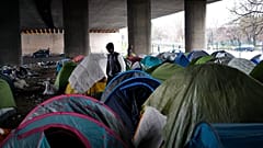 Migrants in a makeshift camp alongside the Porte de la Villette bridge in Paris, in January 2019.