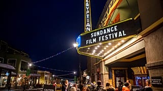 People walk under the marquee of the Egyptian Theatre on the sixth day of the 2020 Sundance Film Festival.