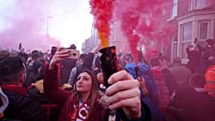 Football supporters set off flares before the English Premier League soccer match between Liverpool and Manchester United near Anfield Stadium in Liverpool.