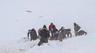 Security officers and villagers carry a victim of an avalanche near the town of Bahcesehir, in the eastern Turkey province of Van, on February 5, 2020.