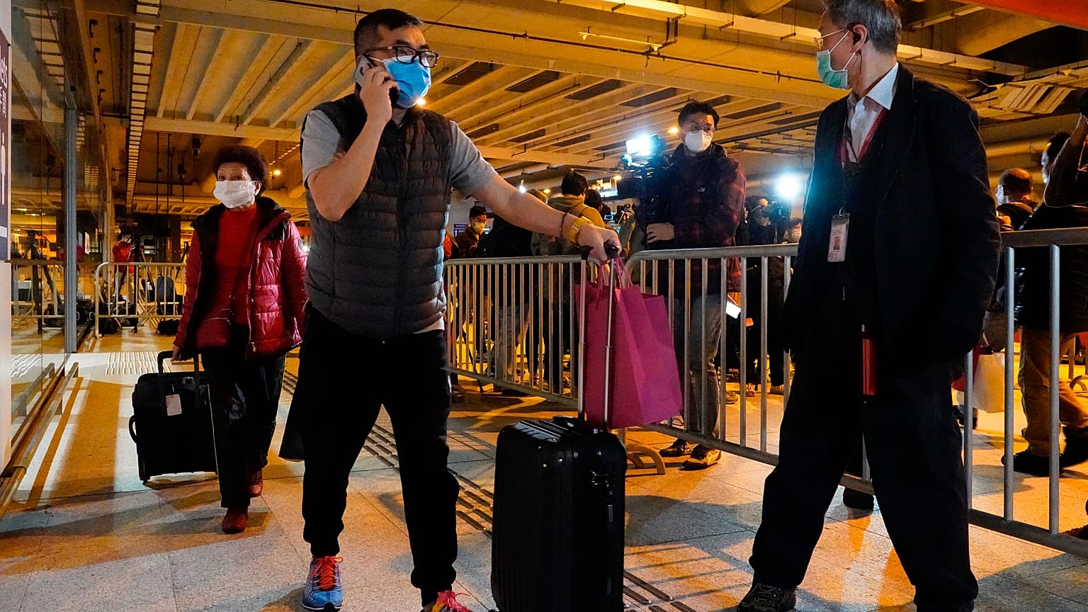 Passengers from the cruise ship World Dream docked at Kai Tak cruise terminal leave the ship after be quarantined for the coronavirus in Hong Kong, Sunday, Feb. 9, 2020
