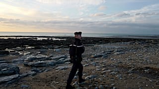 French gendarme patrols the beach in Ambleteuse near Calais, northern France.
