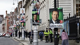 Election posters are displayed on lampposts outside the Irish Prime Minister offices in Dublin, Ireland, Friday, Feb. 7, 2020.