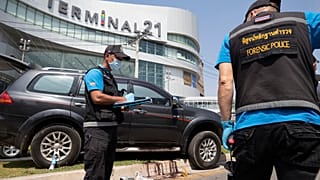Forensic officers inspect a shooting scene outside the Terminal 21 Korat mall in Nakhon Ratchasima, Thailand, Sunday, Feb. 9, 2020.
