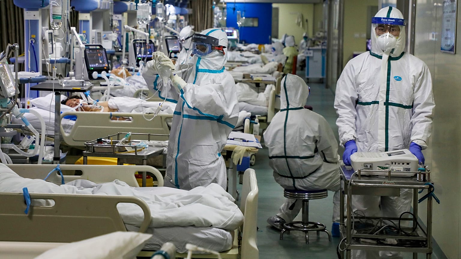 Medical workers treat patients in the isolated intensive care unit at a hospital in Wuhan in central China's Hubei province.