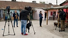 FILE PHOTO: Television reporters stand outside the house of Severin Krassimirov, suspect in the killing of journalist Viktoria Marinova 
