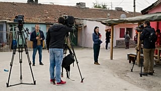 FILE PHOTO: Television reporters stand outside the house of Severin Krassimirov, suspect in the killing of journalist Viktoria Marinova