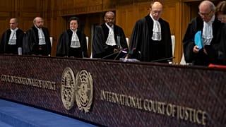 Presiding judge Abdulqawi Ahmed Yusuf, center, and other judges take their seats at the International Court in The Hague, Netherlands, Thursday, Jan. 23, 2020