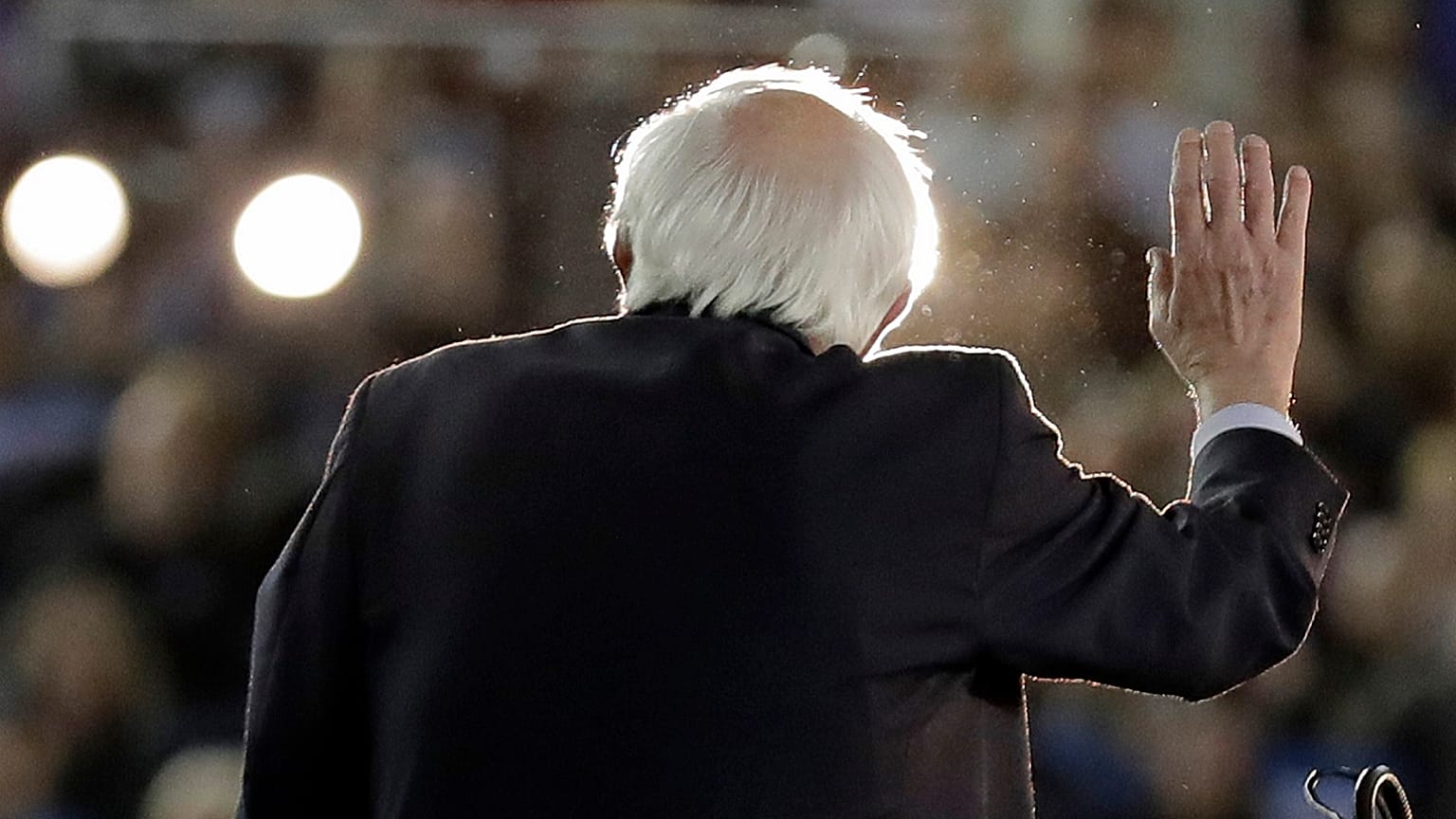 Democratic presidential candidate Sen. Bernie Sanders I-Vt., is lit by spotlights as he speaks at a campaign event in Tacoma, Wash., Monday, Feb. 17, 2020