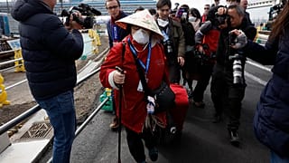 Passengers begin being taken off the quarantined Diamond Princess cruise ship Wednesday, Feb. 19, 2020, in Yokohama, near Tokyo. (AP Photo/Jae C. Hong)