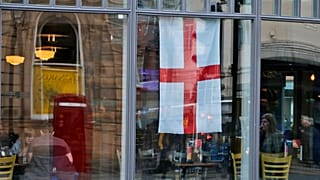 People sit in a pub, decorated with an English flag in Sunderland, England, March 13, 2019. (AP Photo/Frank Augstein)