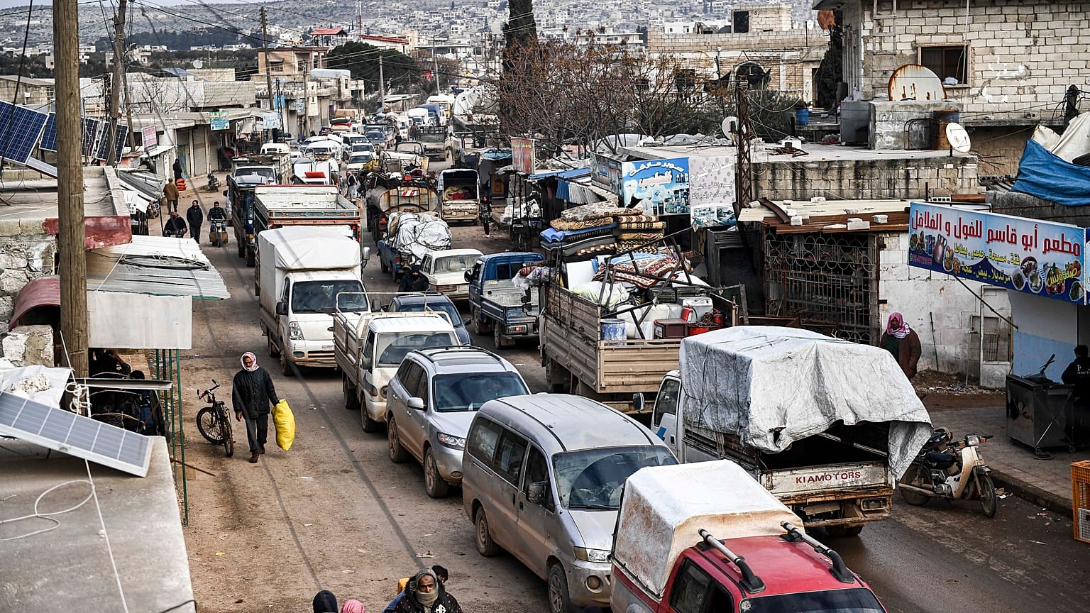 Civilians flee from Idlib toward the north to find safety inside Syria near the border with Turkey, Saturday, Feb. 15, 2020.