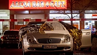 A car with dead bodies stands in front of a bar in Hanua, Germany Thursday, Feb. 20,