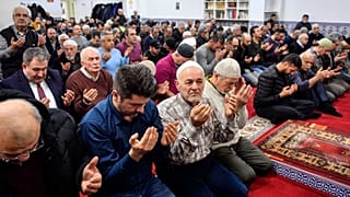 Muslim believers pray in a mosque for the victims of the shooting in Hanau, Germany, Friday, Feb. 21, 2020. 