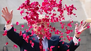 President Donald Trump throws rose petals during a ceremony at the Raj Ghat Mahatma Gandhi Memorial, in New Delhi, India.