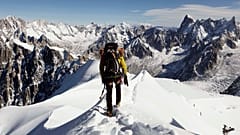 an alpinist heads down a ridge on the Aiguille du Midi towards the Vallee Blanche on the Mont Blanc massif, in the Alps, France on Oct. 12, 2011.