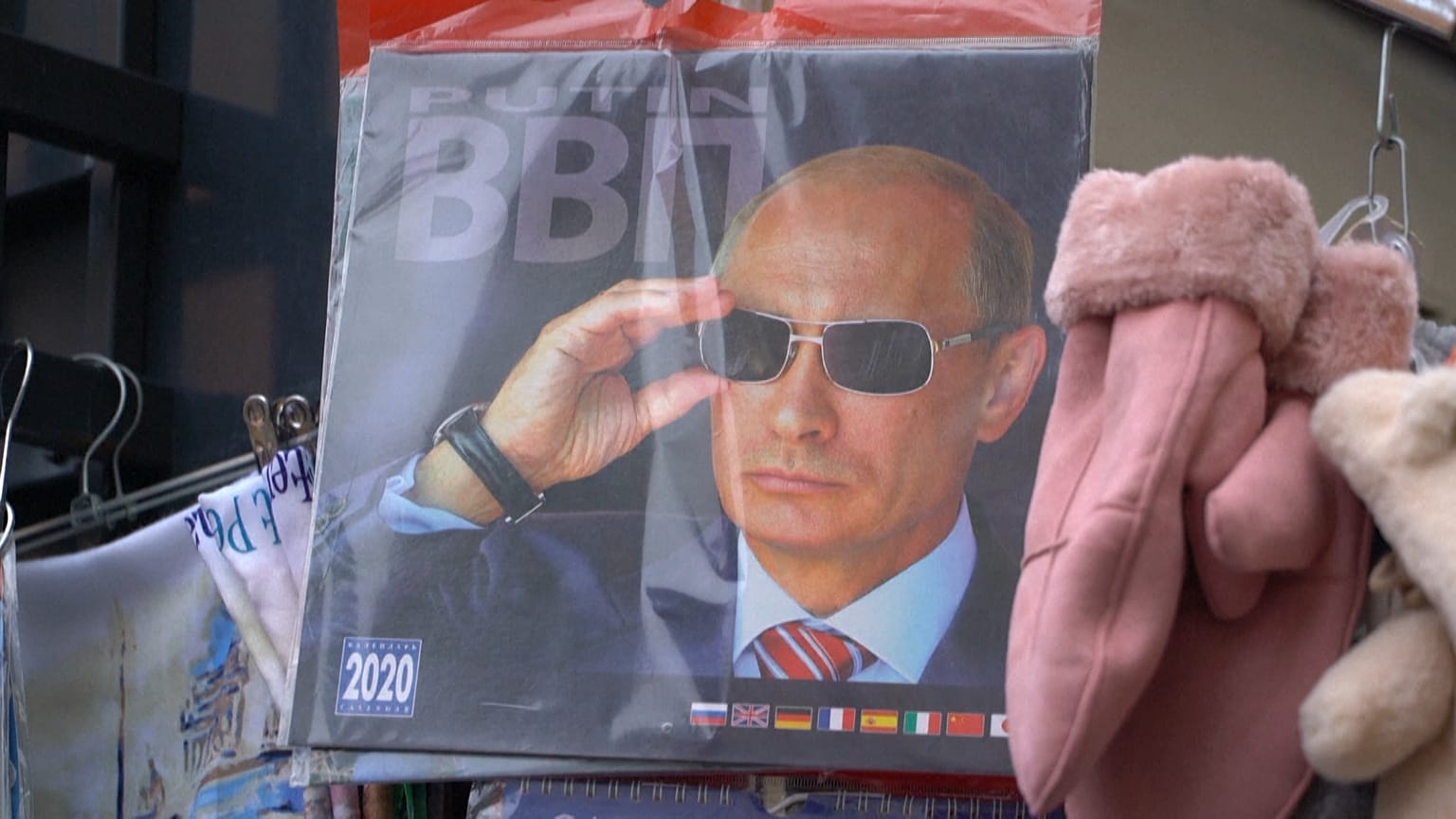 On magnets, mugs and matryoshka dolls, Putin's face still sells