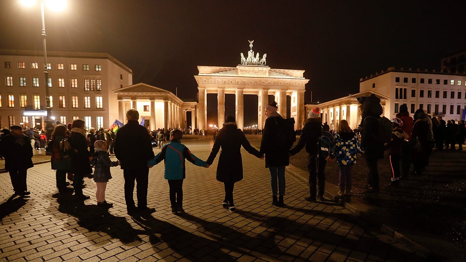 A vigil for victims of last night's shooting in Hanau is held in front of the Brandenburg Gate in Berlin, Germany, Thursday, Feb. 20, 2020. 