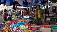 Palestinians buy sweets for upcoming Eid al-Adha holiday at the central Gaza main market in Gaza City, in the northern Gaza Strip