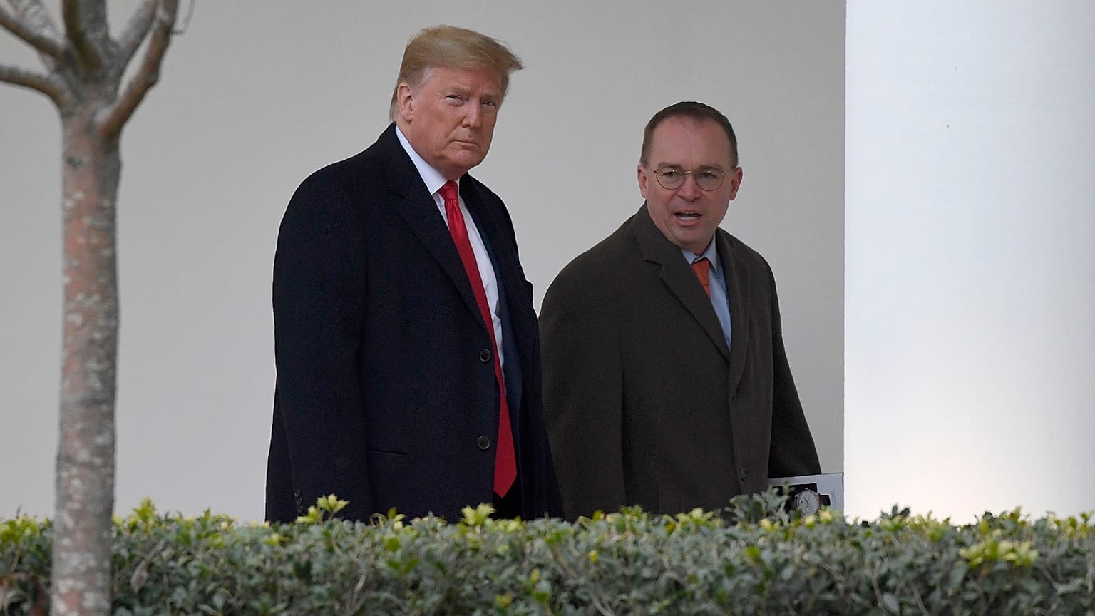 President Donald Trump, left, and acting White House chief of staff Mick Mulvaney, right, walk along the colonnade of the White House in Washington