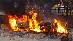 Carts belonging to street vendors go up in flames after clashes in New Delhi 