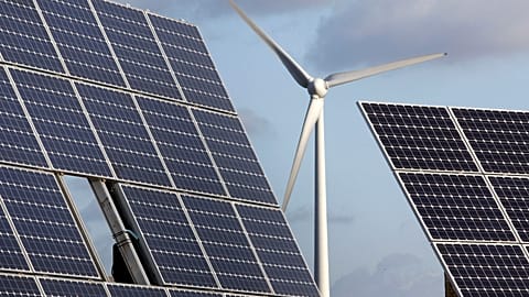 Photovoltaic modules and a windmill are pictured at the village of Feldheim near Berlin, Germany.