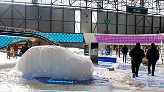 Workers dismantle a booth after that the 90th Geneva International Motor Show is cancelled by Swiss authorities, Friday, Feb. 28, 2020.