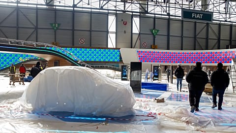Workers dismantle a booth after that the 90th Geneva International Motor Show is cancelled by Swiss authorities, Friday, Feb. 28, 2020.
