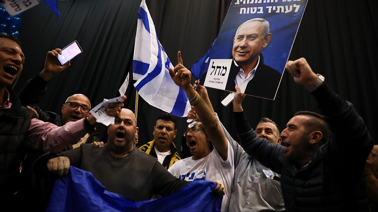 Supporters of Israeli Prime Minister Benjamin Netanyahu celebrate after first exit poll results for Israeli elections in Tel Aviv, Israel, Monday, March 2, 2020. 