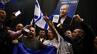 Supporters of Israeli Prime Minister Benjamin Netanyahu celebrate after first exit poll results for Israeli elections in Tel Aviv, Israel, Monday, March 2, 2020. 