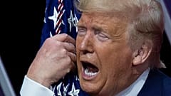 President Donald Trump kisses the American flag after speaking at Conservative Political Action Conference, at the National Harbor, in Oxon Hill, Md., Saturday, Feb. 29, 2020