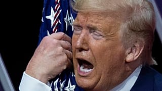 President Donald Trump kisses the American flag after speaking at Conservative Political Action Conference, at the National Harbor, in Oxon Hill, Md., Saturday, Feb. 29, 2020