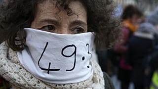 A woman in Marseille protests against the government's use of Article 49.3 of the Constitution to bypass parliament over pension reform.