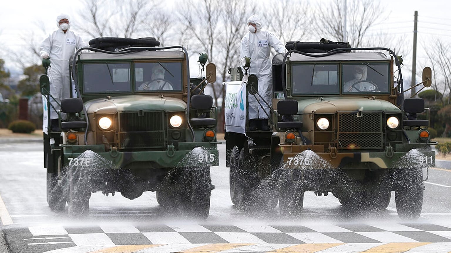 Army trucks spray disinfectant against coronavirus on a street Ulsan, South Korea