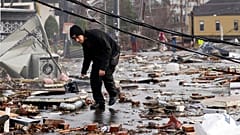 A man walks through storm debris following a deadly tornado in Nashville, Tennessee, USA. 