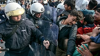 Migrants scuffle with Greek police at the port of Mytilene after locals block access to the Moria refugee camp, on the northeastern Aegean island of Lesbos, Greece