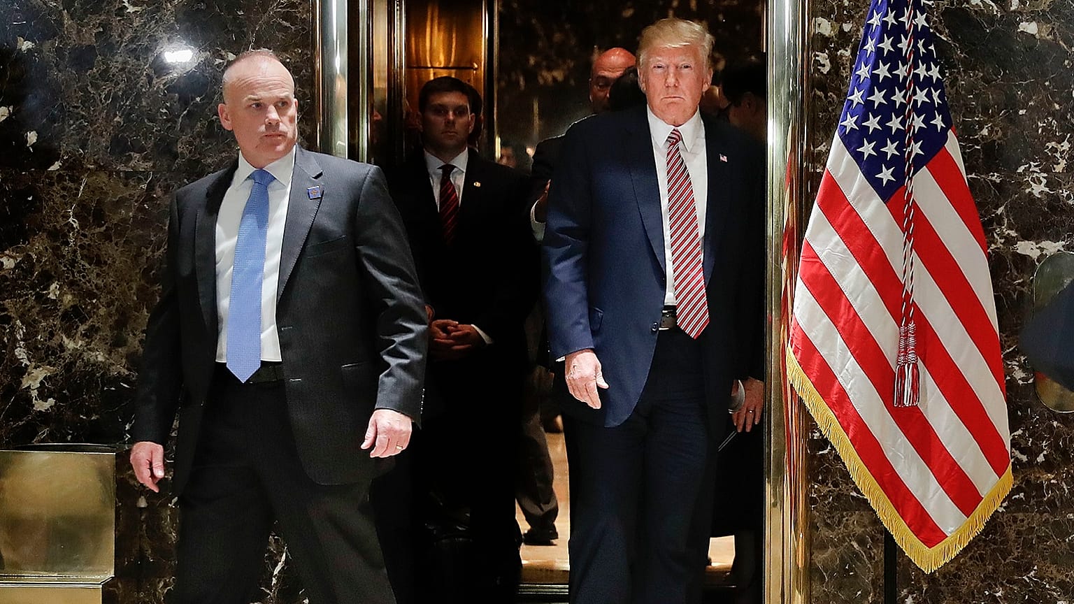 President Donald Trump steps out of the elevator to speak to the media in the lobby of Trump Tower in New York