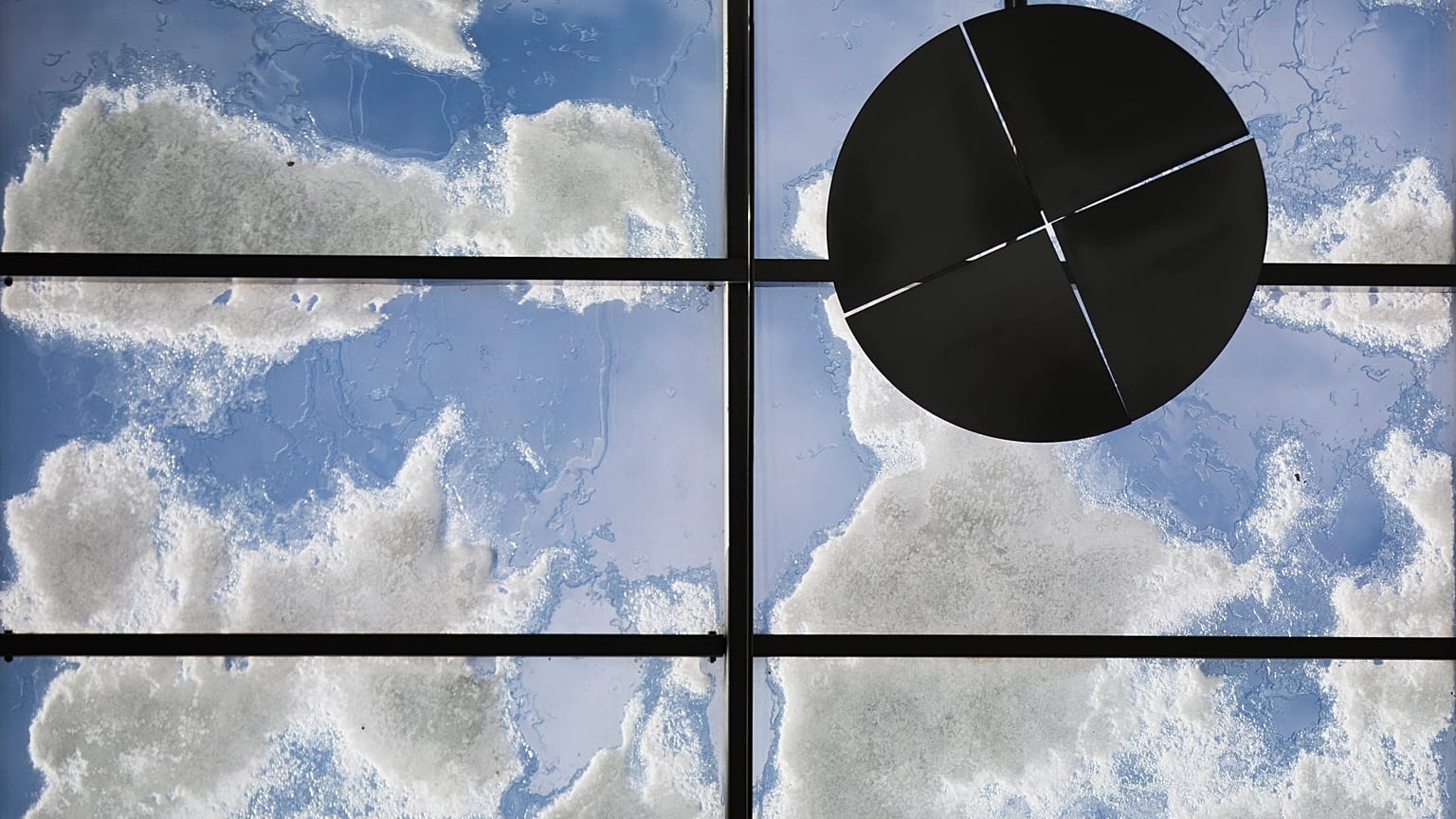 Melting snow is seen on a glass roof above a in Berlin, Germany, Wednesday, March 13, 2013. 
