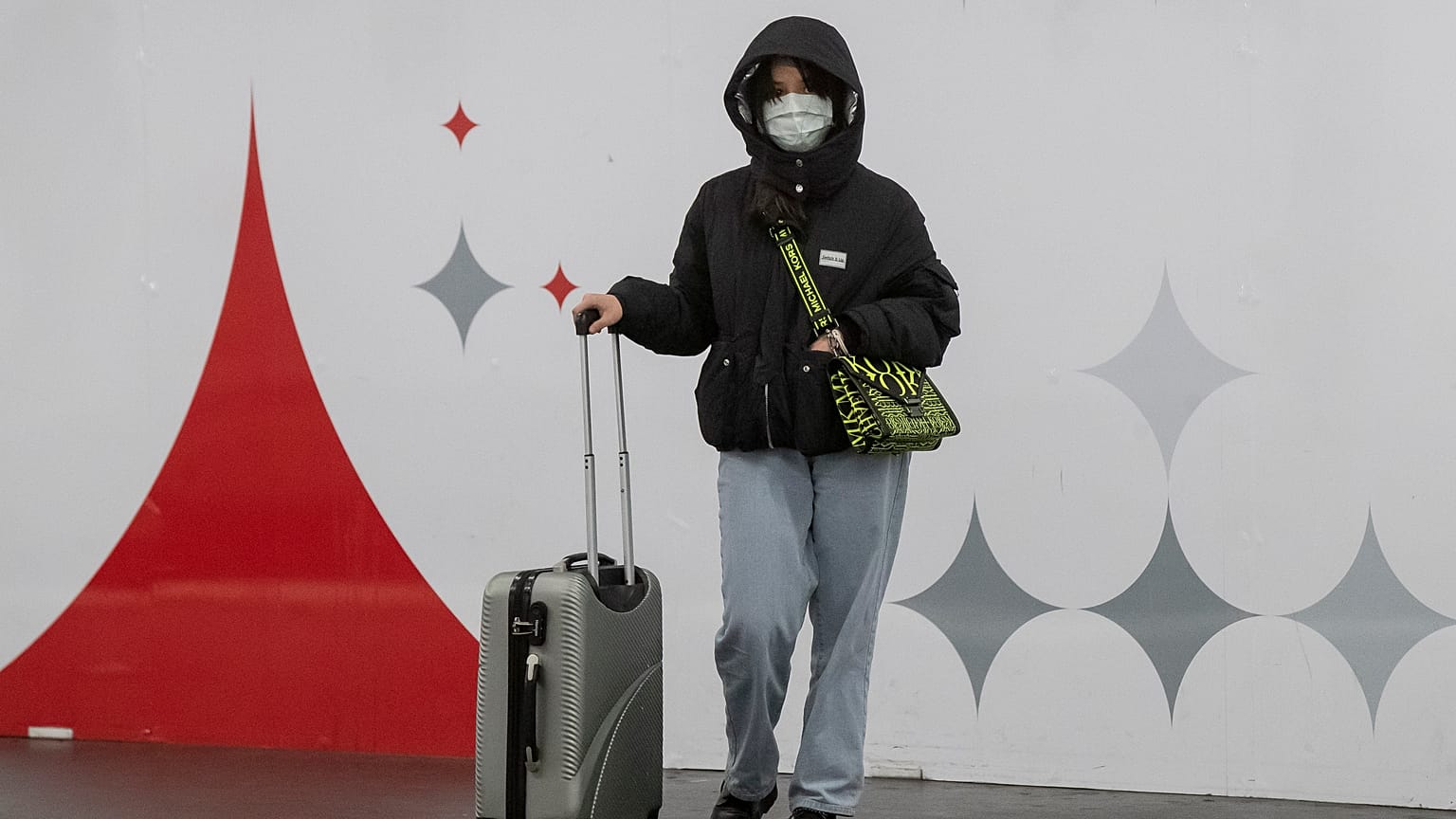 A woman wears a mask as she waits for a train in Paris, Friday, March 6, 2020. 